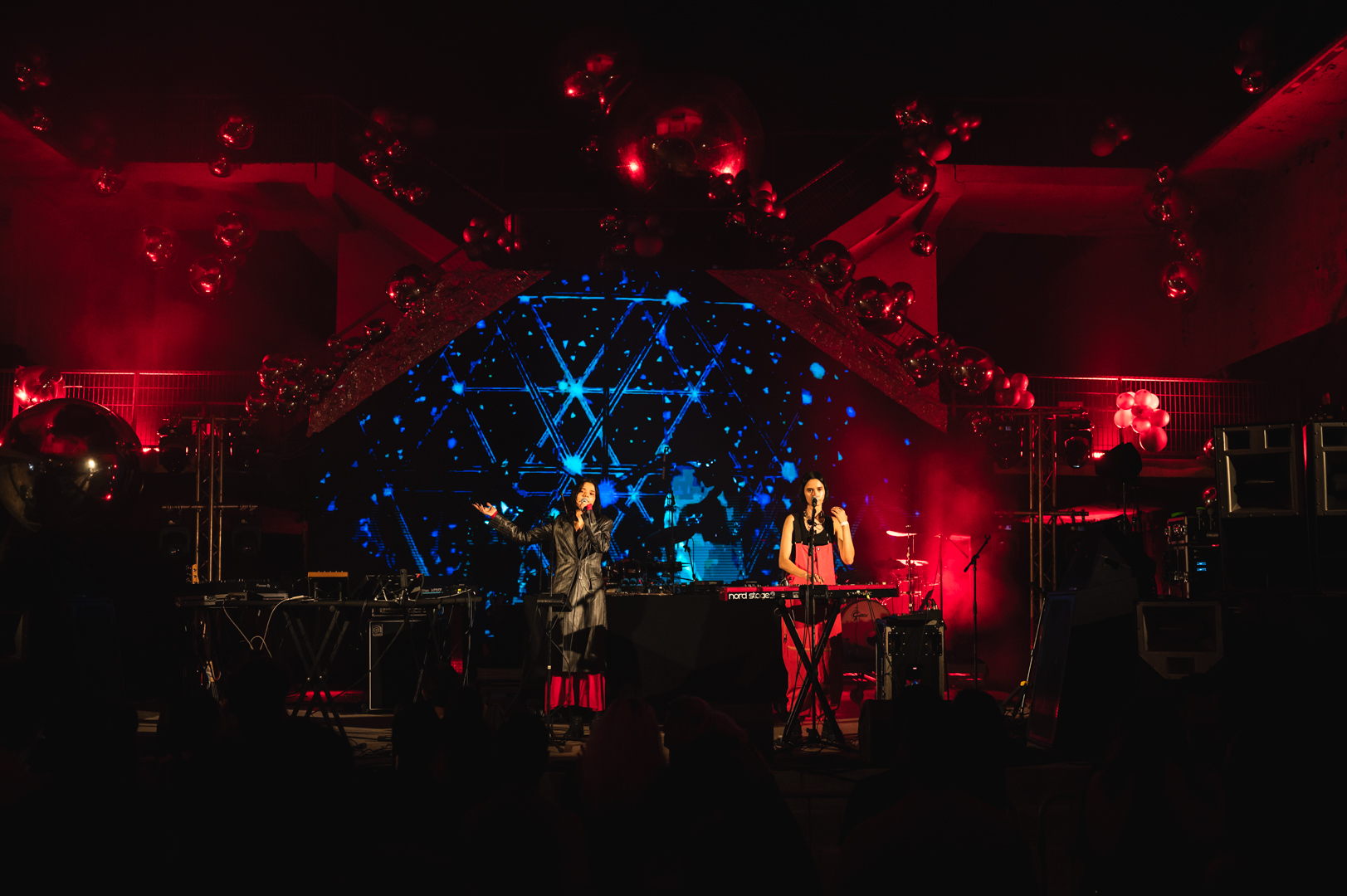 Bloom Twins on stage with blue pyramid screen