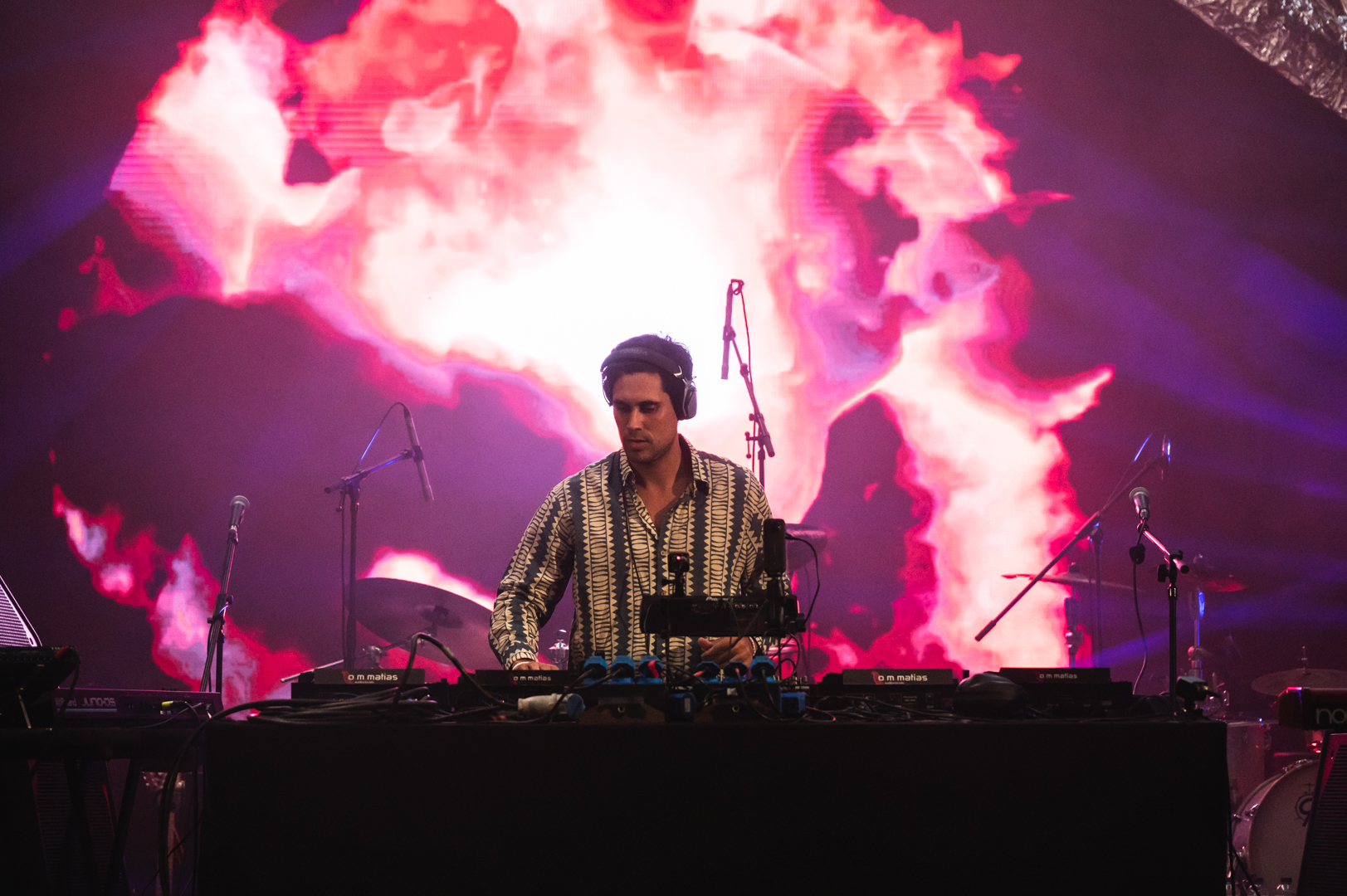 DJ performing with pink fire visuals